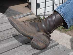 Photo of a man with his foot up on a table displaying the heel on his packer boot.