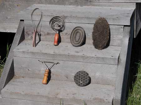 Photo of the various tools used in grooming displayed on two wooden steps.