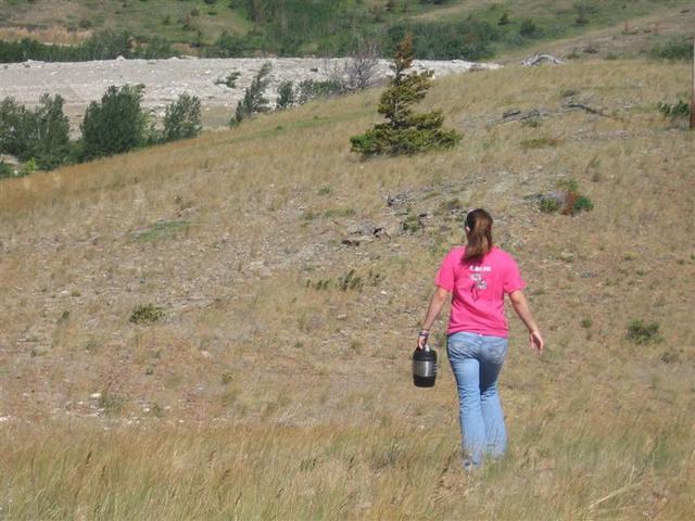 Kelsey delivering water for the weed pulling crew