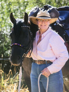 President Kathy Hundley with her horse Gus